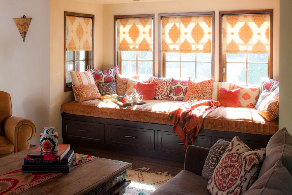 The daybed was outfitted in a relatively monochromatic play on reds and oranges, infusing a symphony of textiles with different textures and patterns to create a generous nook which embodies the warmth and color central to the client's vision.