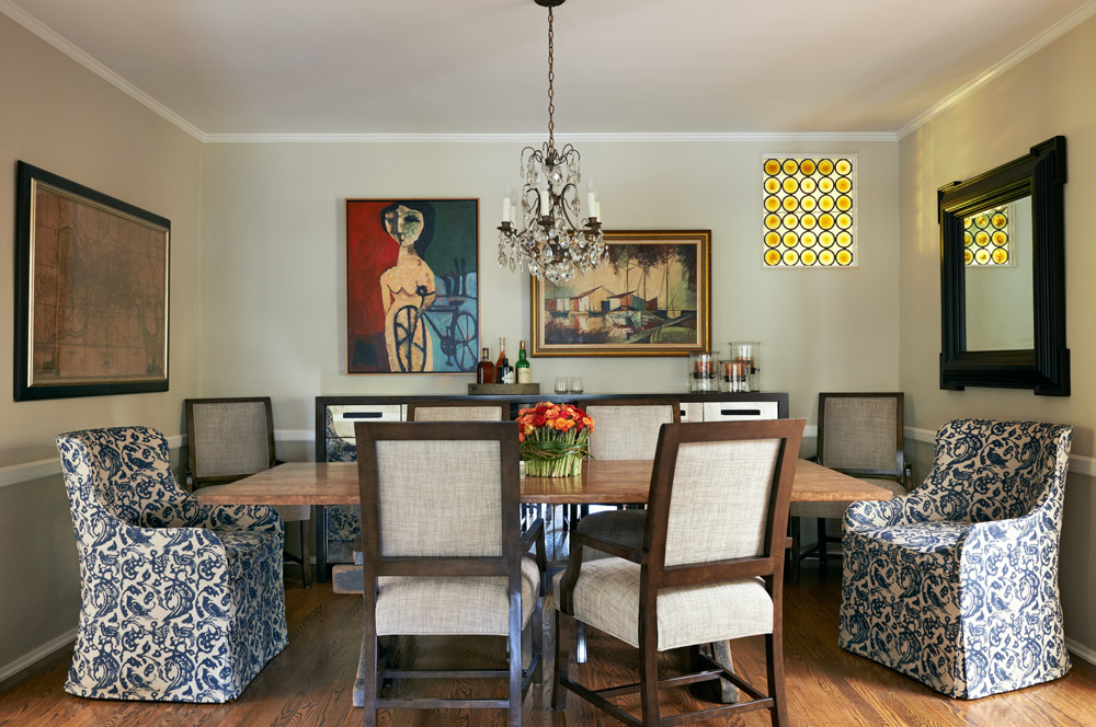 Another view showing the dining room connection to the kitchen and reveals the weathered, farmhouse style base of the table. A glimpse of the dining console reflects the antiqued mirrored fronts.